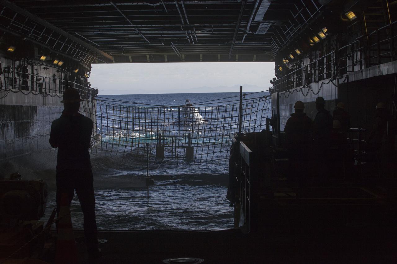 A test version of the Orion crew module floats outside the well deck of the USS San Diego during Underway Recovery Test 5 in the Pacific Ocean off the coast of California. NASA's Ground Systems Development and Operations Program and the U.S. Navy are conducting a series of tests using the ship's well deck, several watercraft, support equipment and personnel to prepare for recovery of Orion on its return from deep space missions. The testing will allow the team to demonstrate and evaluate recovery processes, procedures, hardware and personnel in open waters. Orion is the exploration spacecraft designed to carry astronauts to destinations not yet explored by humans, including an asteroid and NASA's Journey to Mars. It will have emergency abort capability, sustain the crew during space travel and provide safe re-entry from deep space return velocities. Orion is scheduled to launch on NASA's Space Launch System in late 2018. For more information, visit http://www.nasa.gov/orion.