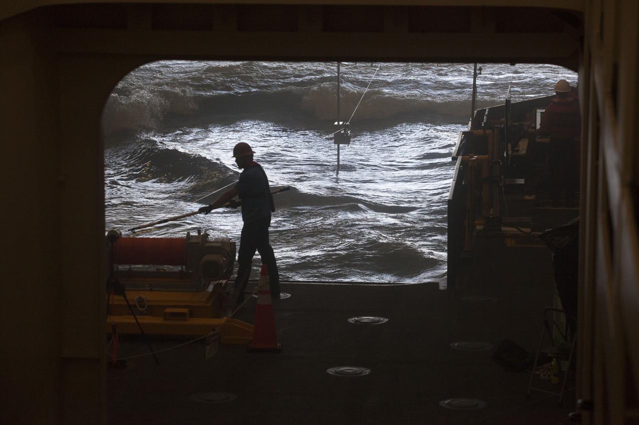 Inside the well deck of the USS San Diego, a winch operator prepares for Underway Recovery Test 5 in the Pacific Ocean off the coast of California. NASA's Ground Systems Development and Operations Program and the U.S. Navy are practicing recovery techniques to prepare for recovery of Orion on its return from deep space missions. The testing will allow the team to demonstrate and evaluate recovery processes, procedures, hardware and personnel in open waters. Orion is the exploration spacecraft designed to carry astronauts to destinations not yet explored by humans, including an asteroid and NASA's Journey to Mars. It will have emergency abort capability, sustain the crew during space travel and provide safe re-entry from deep space return velocities. Orion is scheduled to launch on NASA's Space Launch System in late 2018. For more information, visit http://www.nasa.gov/orion.