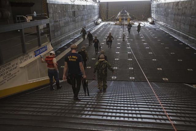 U. S. Navy divers and other personnel enter the well deck of the USS San Diego after another day of Underway Recovery Test 5 using a test version of the Orion crew module and several rigid hull inflatable and Zodiac boats in the Pacific Ocean off the coast of California. The test module is secured at the far end of the well deck. NASA's Ground Systems Development and Operations Program and the U.S. Navy are conducting a series of tests to prepare for recovery of Orion on its return from deep space missions. The testing allows the team to demonstrate and evaluate recovery processes, procedures, hardware and personnel in open waters. Orion is the exploration spacecraft designed to carry astronauts to destinations not yet explored by humans, including an asteroid and NASA's Journey to Mars. It will have emergency abort capability, sustain the crew during space travel and provide safe re-entry from deep space return velocities. Orion is scheduled to launch on NASA's Space Launch System in late 2018. For more information, visit http://www.nasa.gov/orion. 