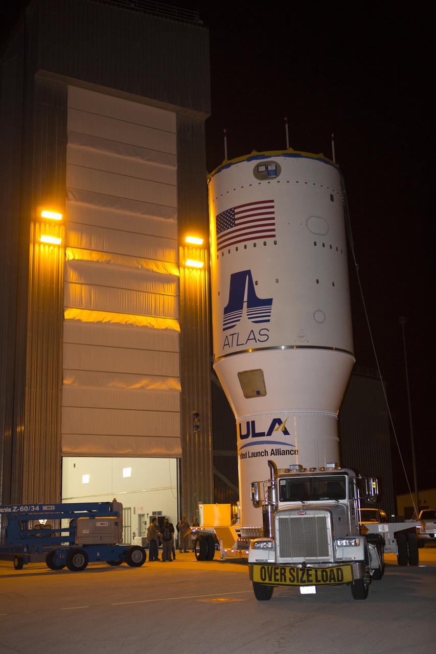 The United Launch Alliance Atlas V Centaur second stage departs the Launch Vehicle Integration Facility aboard a transport trailer for delivery to the Vertical Integration Facility at Space Launch Complex 41 at Cape Canaveral Air Force Station in Florida. The Geostationary Operational Environmental Satellite (GOES-R) will launch aboard the Atlas V rocket in November. GOES-R is the first satellite in a series of next-generation NOAA GOES Satellites.