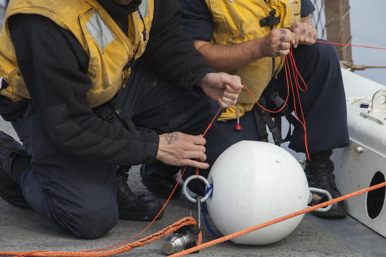 U.S. Navy personnel check tether and winch lines on the deck of the USS San Diego to prepare for Underway Recovery Test 5 in the Pacific Ocean off the coast of California. NASA's Ground Systems Development and Operations Program and the U.S. Navy are conducting a series of tests using the ship's well deck, a test version of the Orion crew module, various watercraft and equipment to prepare for recovery of Orion on its return from deep space missions. The testing will allow the team to demonstrate and evaluate recovery processes, procedures, hardware and personnel in open waters. Orion is the exploration spacecraft designed to carry astronauts to destinations not yet explored by humans, including an asteroid and NASA's Journey to Mars. It will have emergency abort capability, sustain the crew during space travel and provide safe re-entry from deep space return velocities. Orion is scheduled to launch on NASA's Space Launch System in late 2018. For more information, visit http://www.nasa.gov/orion. 