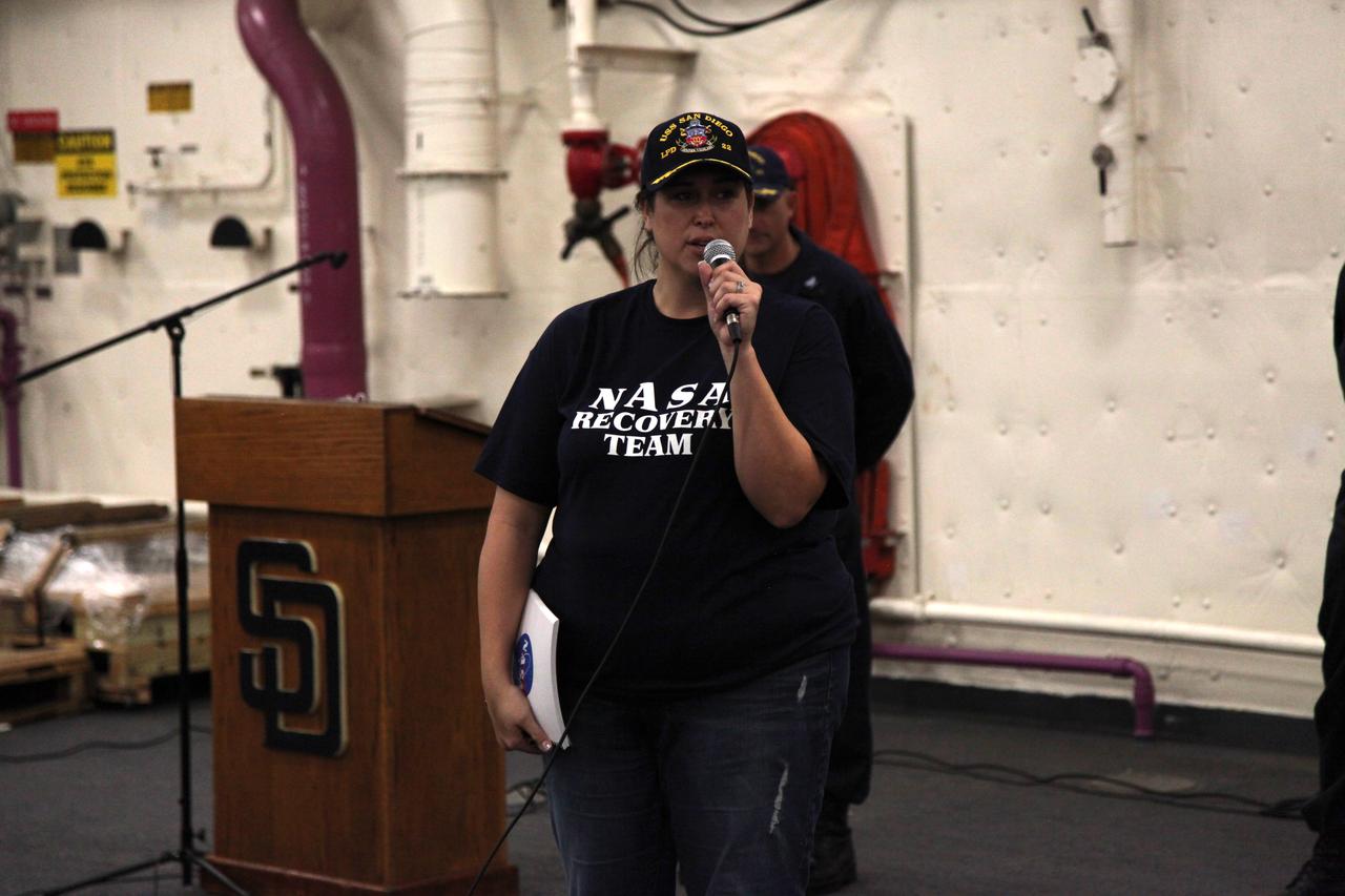 Melissa Jones, Landing and Recovery director with NASA's Ground Systems Development and Operations Program (GSDO) speaks to the recovery team during wrap up of Underway Recovery Test 5 aboard the USS San Diego. GSDO and the U.S. Navy practiced recovery techniques using the well deck of the ship and a test version of the Orion crew module in the Pacific Ocean off the coast of California to prepare for recovery of Orion on its return from deep space missions. The testing allowed the team to demonstrate and evaluate recovery processes, procedures, hardware and personnel in open waters. Orion is the exploration spacecraft designed to carry astronauts to destinations not yet explored by humans, including an asteroid and NASA's Journey to Mars. It will have emergency abort capability, sustain the crew during space travel and provide safe re-entry from deep space return velocities. Orion is scheduled to launch on NASA's Space Launch System in late 2018. For more information, visit http://www.nasa.gov/orion. 