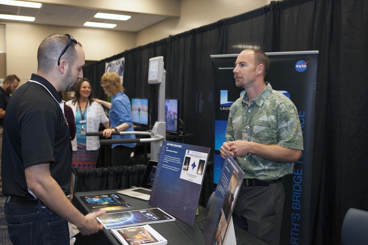 Visitors stop by a NASA booth in the Space Station Processing Facility conference center at NASA's Kennedy Space Center during the 2016 Innovation Expo. Now in its fifth year, the purpose of the Innovation Expo is to help foster innovation and creativity among Kennedy employees who are encouraged to look for ways to do their work better and to propose concepts for tackling future mission needs.