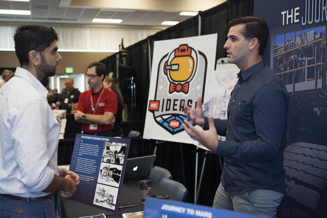 Visitors stop by a NASA booth in the Space Station Processing Facility conference center at NASA's Kennedy Space Center during the 2016 Innovation Expo. Now in its fifth year, the purpose of the Innovation Expo is to help foster innovation and creativity among Kennedy employees who are encouraged to look for ways to do their work better and to propose concepts for tackling future mission needs.