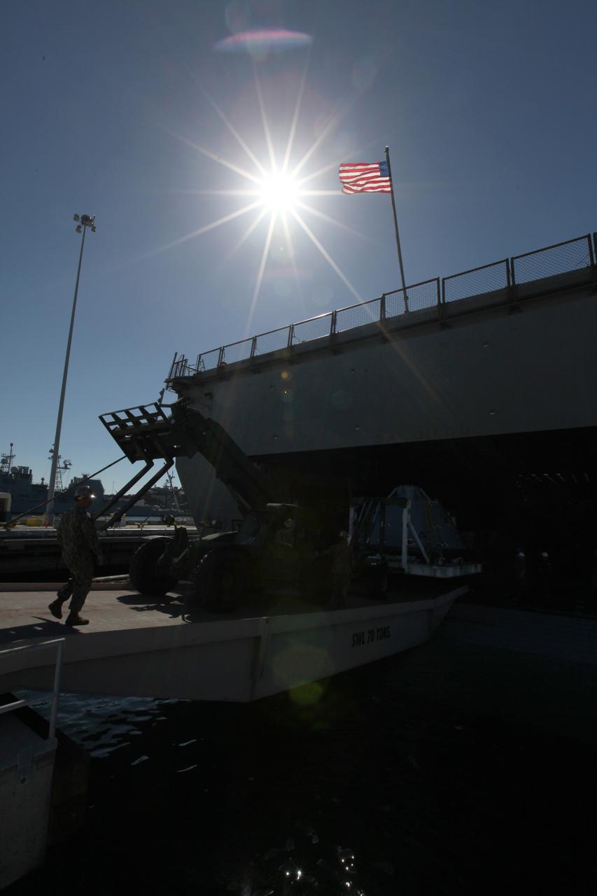 The USS San Diego is docked at Naval Base San Diego in California after returning from Underway Recovery Test 5 in the Pacific Ocean. A test version of the Orion crew module is being offloaded from the well deck of the ship. NASA's Ground Systems Development and Operations Program and the U.S. Navy completed a series of tests using the ship's well deck, the test module, various watercraft and equipment to prepare for recovery of Orion on its return from deep space missions. The testing allowed the team to demonstrate and evaluate recovery processes, procedures, hardware and personnel in open waters. Orion is the exploration spacecraft designed to carry astronauts to destinations not yet explored by humans, including an asteroid and NASA's Journey to Mars. It will have emergency abort capability, sustain the crew during space travel and provide safe re-entry from deep space return velocities. Orion is scheduled to launch on NASA's Space Launch System in late 2018. For more information, visit http://www.nasa.gov/orion. 