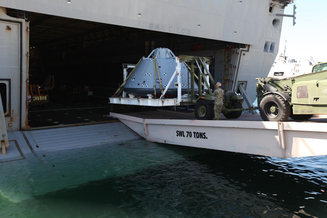 The USS San Diego is docked at Naval Base San Diego in California after returning from Underway Recovery Test 5 in the Pacific Ocean. A test version of the Orion crew module is being offloaded from the well deck of the ship. NASA's Ground Systems Development and Operations Program and the U.S. Navy completed a series of tests using the ship's well deck, the test module, various watercraft and equipment to prepare for recovery of Orion on its return from deep space missions. The testing allowed the team to demonstrate and evaluate recovery processes, procedures, hardware and personnel in open waters. Orion is the exploration spacecraft designed to carry astronauts to destinations not yet explored by humans, including an asteroid and NASA's Journey to Mars. It will have emergency abort capability, sustain the crew during space travel and provide safe re-entry from deep space return velocities. Orion is scheduled to launch on NASA's Space Launch System in late 2018. For more information, visit http://www.nasa.gov/orion.