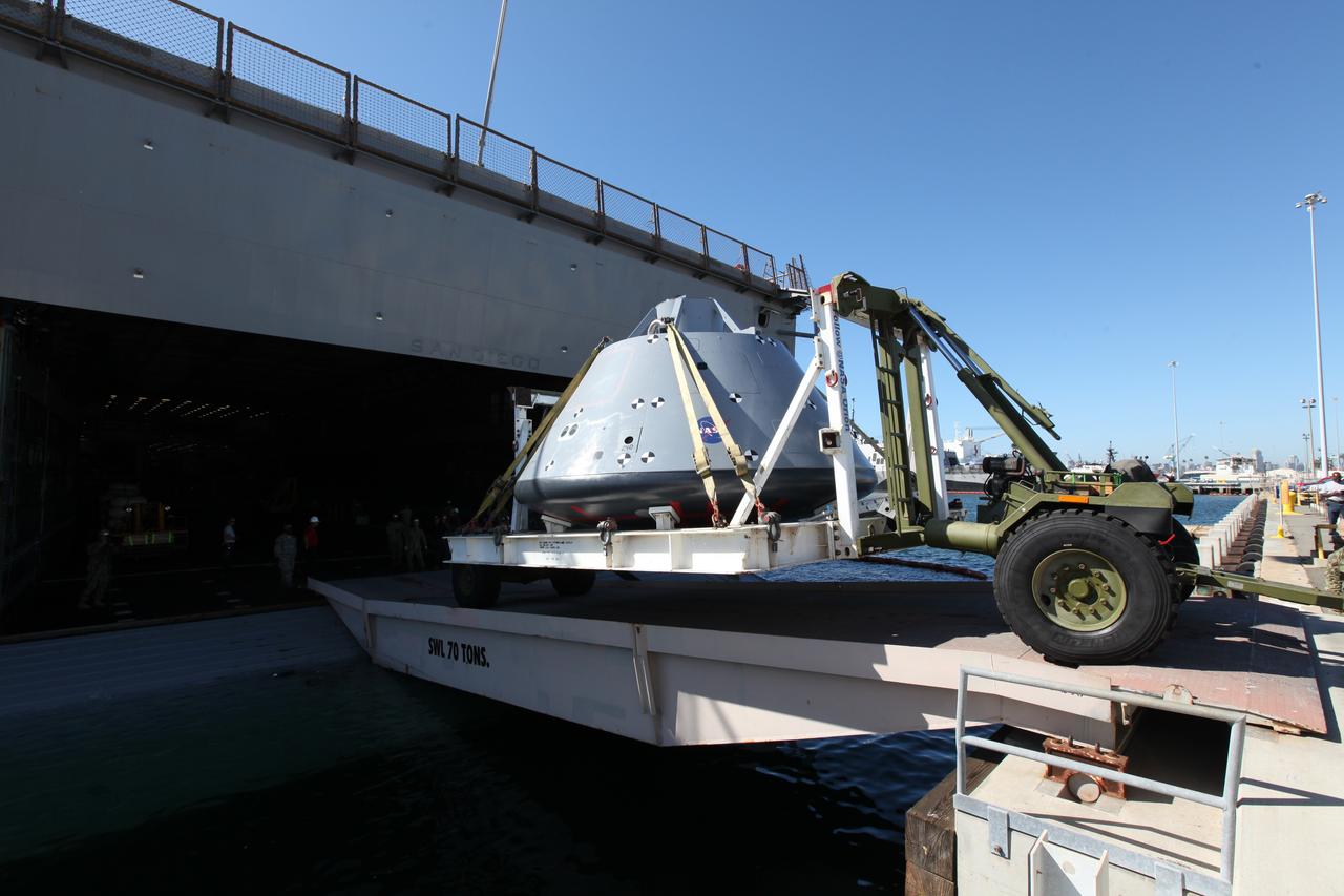 The USS San Diego is docked at Naval Base San Diego in California after returning from Underway Recovery Test 5 in the Pacific Ocean. A test version of the Orion crew module is being offloaded from the well deck of the ship. NASA's Ground Systems Development and Operations Program and the U.S. Navy completed a series of tests using the ship's well deck, the test module, various watercraft and equipment to prepare for recovery of Orion on its return from deep space missions. The testing allowed the team to demonstrate and evaluate recovery processes, procedures, hardware and personnel in open waters. Orion is the exploration spacecraft designed to carry astronauts to destinations not yet explored by humans, including an asteroid and NASA's Journey to Mars. It will have emergency abort capability, sustain the crew during space travel and provide safe re-entry from deep space return velocities. Orion is scheduled to launch on NASA's Space Launch System in late 2018. For more information, visit http://www.nasa.gov/orion.