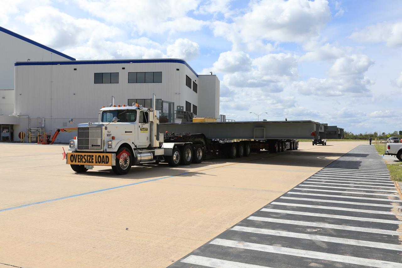 A heavy load transport truck from Tillett Heavy Hauling in Titusville, Florida, arrives at NASA’s Kennedy Space Center in Florida, carrying the second half of the B-level work platforms, B north, for the agency’s Space Launch System (SLS) rocket. The platform will be delivered to the Vehicle Assembly Building (VAB) staging area in the west parking lot. The Ground Systems Development and Operations Program is overseeing upgrades and modifications to VAB High Bay 3 to support processing of the SLS and Orion spacecraft. A total of 10 levels of new platforms, 20 platform halves altogether, will surround the SLS rocket and Orion spacecraft and provide access for testing and processing.