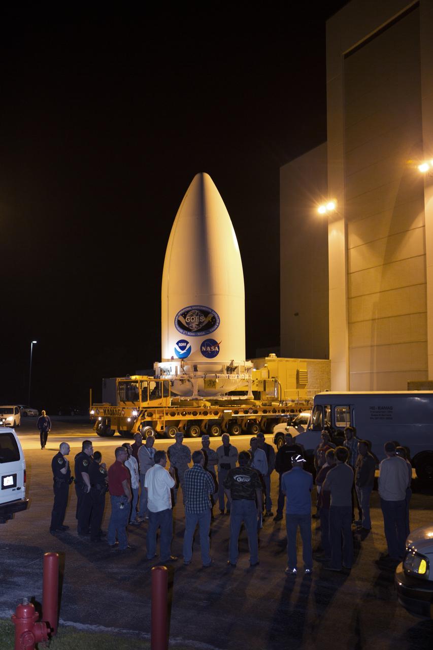 Enclosed in its payload fairing, NOAA's Geostationary Operational Environmental Satellite (GOES-R) departs from the Astrotech payload processing facility in Titusville, Florida, near NASA's Kennedy Space Center. GOES-R will be transported to the Vertical Integration Facility at Space Launch Complex 41 at Cape Canaveral Air Force Station. The satellite will launch aboard a United Launch Alliance Atlas V rocket in November. GOES-R is the first satellite in a series of next-generation NOAA GOES Satellites. 