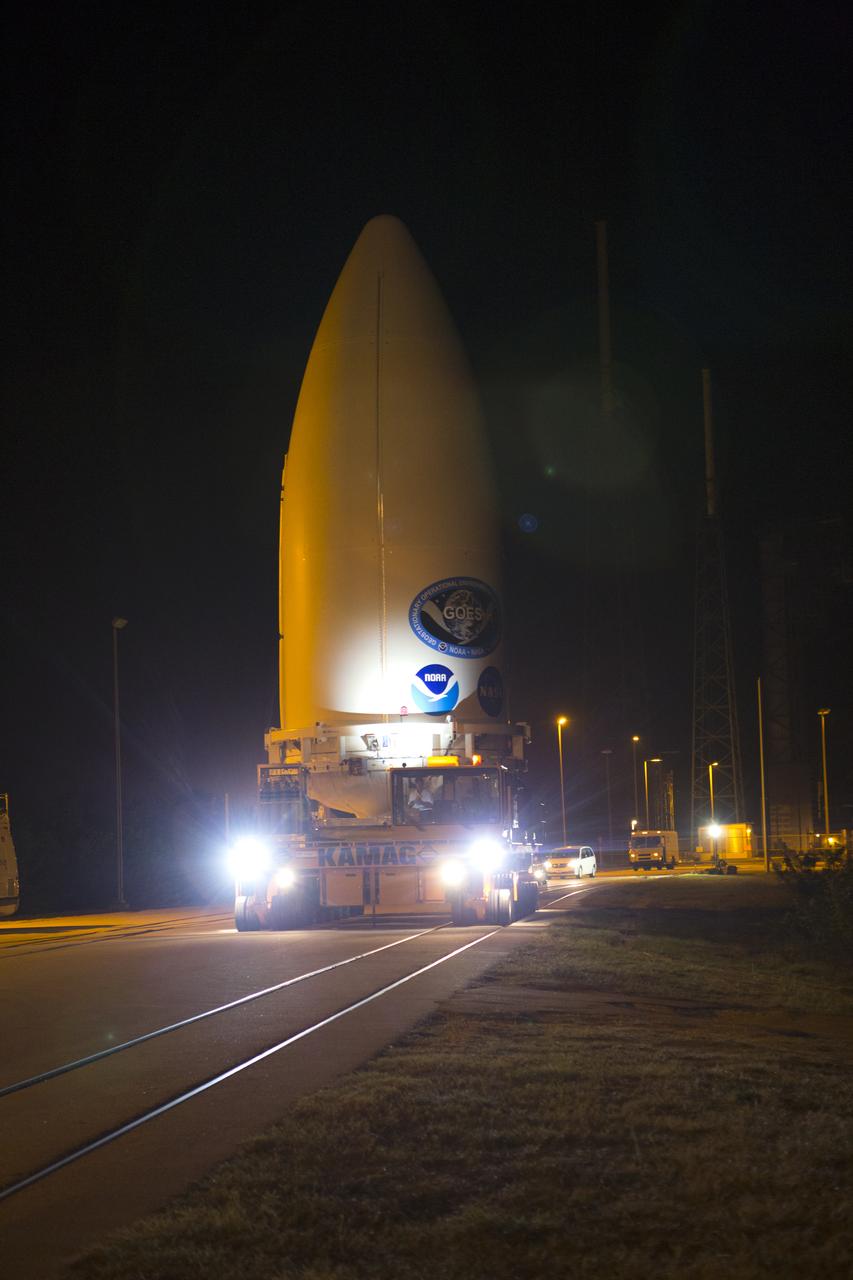 Enclosed in its payload fairing, NOAA's Geostationary Operational Environmental Satellite (GOES-R) is being transported to the Vertical Integration Facility at Space Launch Complex 41 at Cape Canaveral Air Force Station. The satellite will launch aboard a United Launch Alliance Atlas V rocket in November. GOES-R is the first satellite in a series of next-generation NOAA GOES Satellites. 