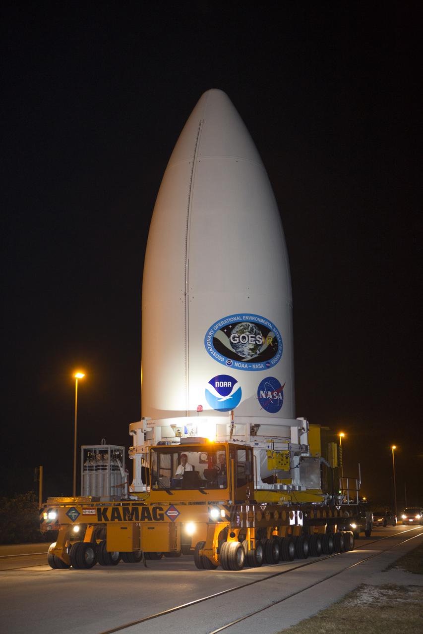 Enclosed in its payload fairing, NOAA's Geostationary Operational Environmental Satellite (GOES-R) is being transported to the Vertical Integration Facility at Space Launch Complex 41 at Cape Canaveral Air Force Station. The satellite will launch aboard a United Launch Alliance Atlas V rocket in November. GOES-R is the first satellite in a series of next-generation NOAA GOES Satellites. 