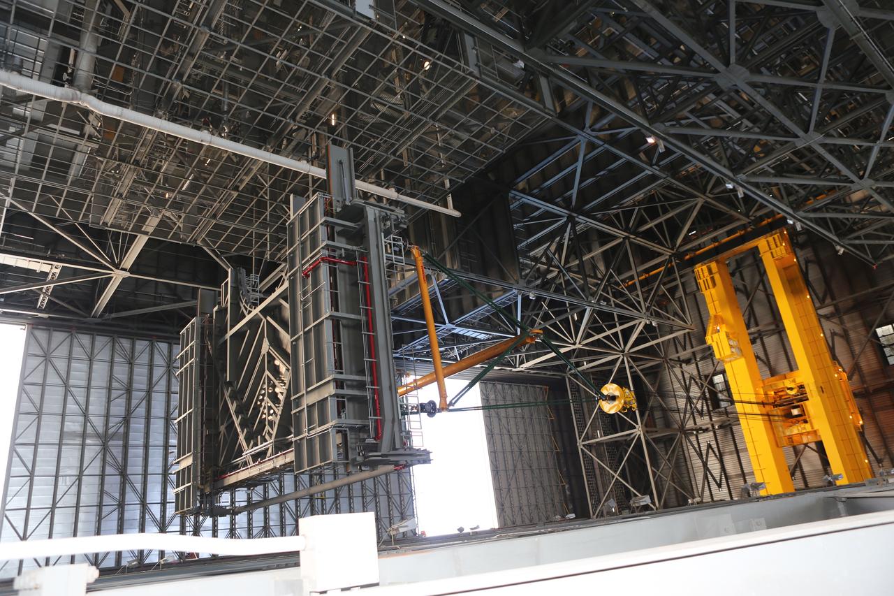 A heavy-lift crane lifts the second half of the C-level work platforms, C north, for NASA’s Space Launch System (SLS) rocket, high up from the transfer aisle floor of the Vehicle Assembly Building (VAB) at NASA’s Kennedy Space Center in Florida. The C platform will be moved into High Bay 3 for installation on the north wall. The C platforms are the eighth of 10 levels of work platforms that will surround and provide access to the SLS rocket and Orion spacecraft for Exploration Mission 1. The Ground Systems Development and Operations Program is overseeing upgrades and modifications to VAB High Bay 3, including installation of the new work platforms, to prepare for NASA’s Journey to Mars. 