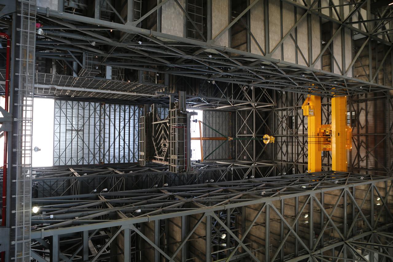 A heavy-lift crane lifts the second half of the C-level work platforms, C north, for NASA’s Space Launch System (SLS) rocket, high up from the transfer aisle of the Vehicle Assembly Building (VAB) at NASA's Kennedy Space Center in Florida. The C platform will be moved into High Bay 3 for installation on the north side of High Bay 3. The C platforms are the eighth of 10 levels of work platforms that will surround and provide access to the SLS rocket and Orion spacecraft for Exploration Mission 1. The Ground Systems Development and Operations Program is overseeing upgrades and modifications to VAB High Bay 3, including installation of the new work platforms, to prepare for NASA’s Journey to Mars. 