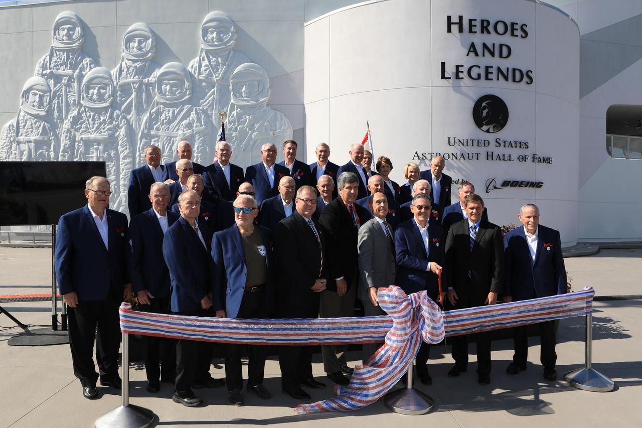 Dignitaries, including members of the U.S. Astronaut Hall of Fame, prepare to cut a ceremonial ribbon opening the Heroes and Legends attraction at the Kennedy Space Center Visitor Complex. The new facility includes the U.S. Astronaut Hall of Fame and looks back to the pioneering efforts of Mercury, Gemini and Apollo. It sets the stage by providing the background and context for space exploration and the legendary men and women who pioneered the nation's journey into space.