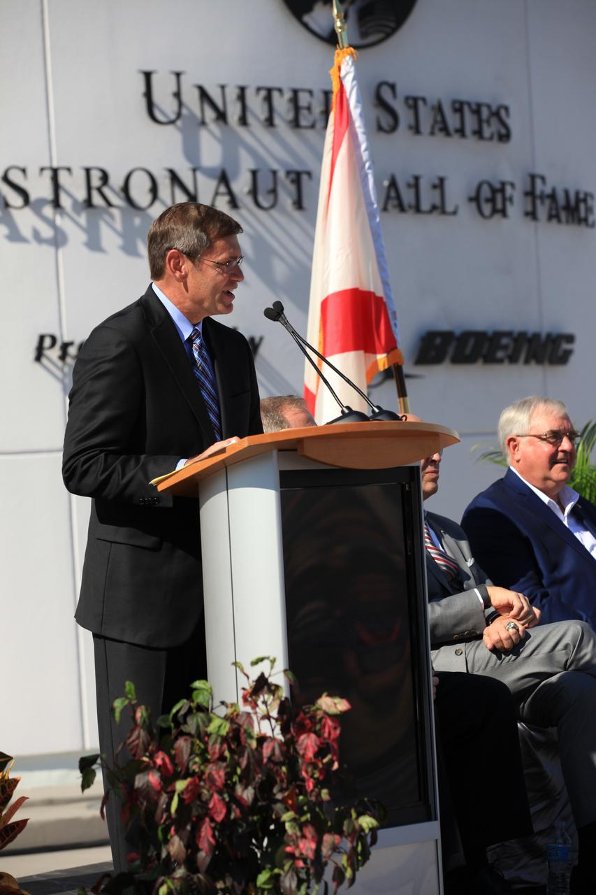 Boeing Vice President and General Manager John Elbon addresses the crowd gathered for the grand opening of the Heroes and Legends attraction at the Kennedy Space Center Visitor Complex. Boeing is sponsoring the new attraction. Seated, to the left, is former space shuttle astronaut Dan Brandenstein, chairman of the Astronaut Scholarship Foundation board of directors. The new facility includes the U.S. Astronaut Hall of Fame and looks back to the pioneering efforts of Mercury, Gemini and Apollo. It sets the stage by providing the background and context for space exploration and the legendary men and women who pioneered the nation's journey into space.
