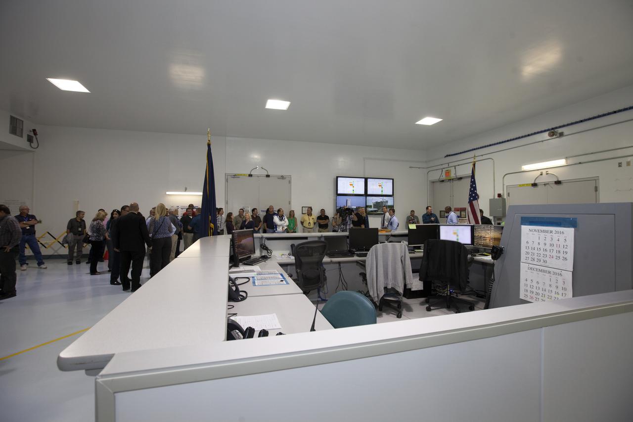 A crowd gathers for a ribbon cutting ceremony in the high bay of the Space Station Processing Facility at NASA's Kennedy Space Center in Florida. The event celebrated completion of facility modifications to improve processing and free up zones tailored to a variety of needs supporting a robust assortment of space-bound hardware including NASA programs and commercial space companies.