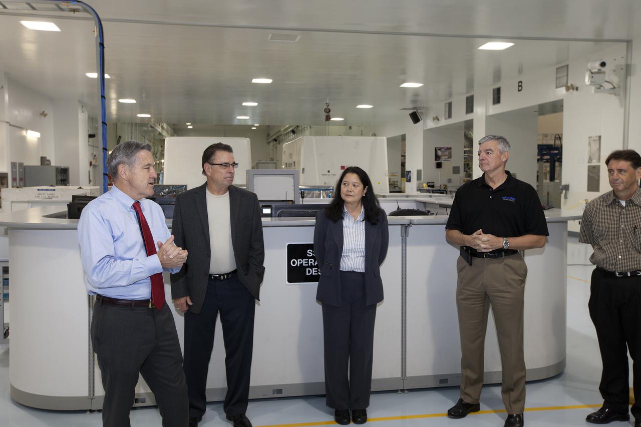 Kennedy Space Center Director Bob Cabana, far left, speaks to guests during a ribbon cutting ceremony in the high bay of the Space Station Processing Facility at the Florida spaceport. Joining Cabana, from the left, are Bill Dowdell, Kennedy's International Space Station technical director, Josephine Burnett, director of Exploration Research and Technology, Andy Allen, Jacobs vice president and general manager and Test and Operations Support Contract program manager, and Jeff McAlear, Jacobs director of Processing Services. The event celebrated completion of facility modifications to improve processing and free up zones tailored to a variety of needs supporting a robust assortment of space-bound hardware including NASA programs and commercial space companies.