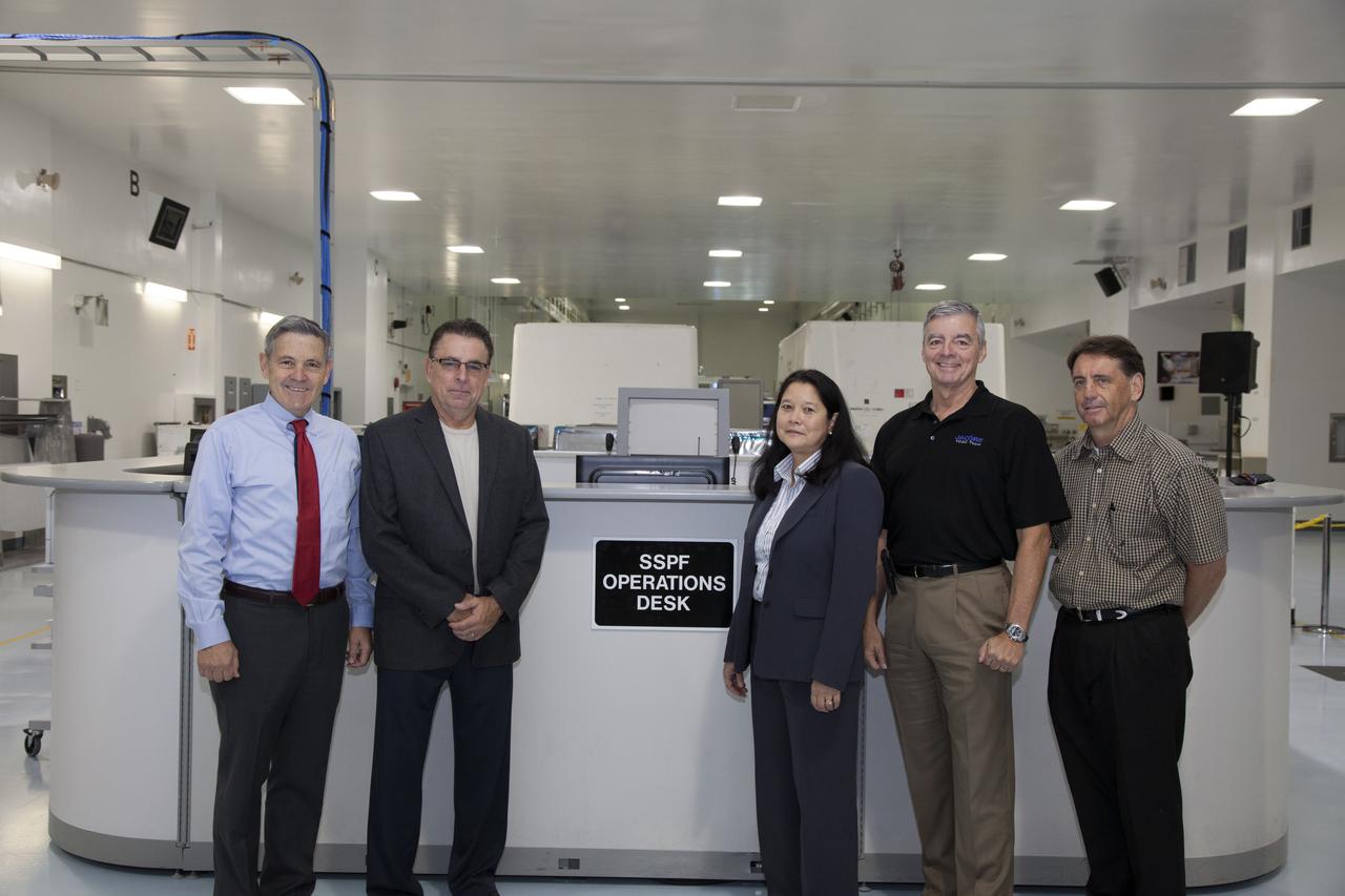 During a ribbon cutting ceremony in the high bay of the Space Station Processing Facility at NASA's Kennedy Space Center in Florida, center director Bob Cabana, far left, is joined by Bill Dowdell, Kennedy's International Space Station technical director, Josephine Burnett, director of Exploration Research and Technology, Andy Allen, Jacobs vice president and general manager and Test and Operations Support Contract program manager, and Jeff McAlear, Jacobs director of Processing Services. The event celebrated completion of facility modifications to improve processing and free up zones tailored to a variety of needs supporting a robust assortment of space-bound hardware including NASA programs and commercial space companies.