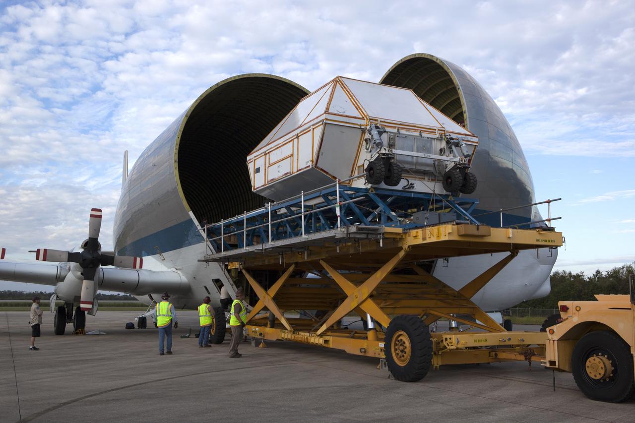 After arriving at the Shuttle Landing Facility operated by Space Florida at NASA's Kennedy Space Center in Florida, the agency's Super Guppy aircraft has been opened and the container holding the Orion crew module structural test article (STA) is being offloaded. The test article will be transported to the Neil Armstrong Operations and Checkout Building high bay for further testing. The Orion spacecraft will launch atop NASA’s Space Launch System rocket on EM-1, its first deep space mission, in late 2018. Photo credit: NASA/Ben Smegelsky