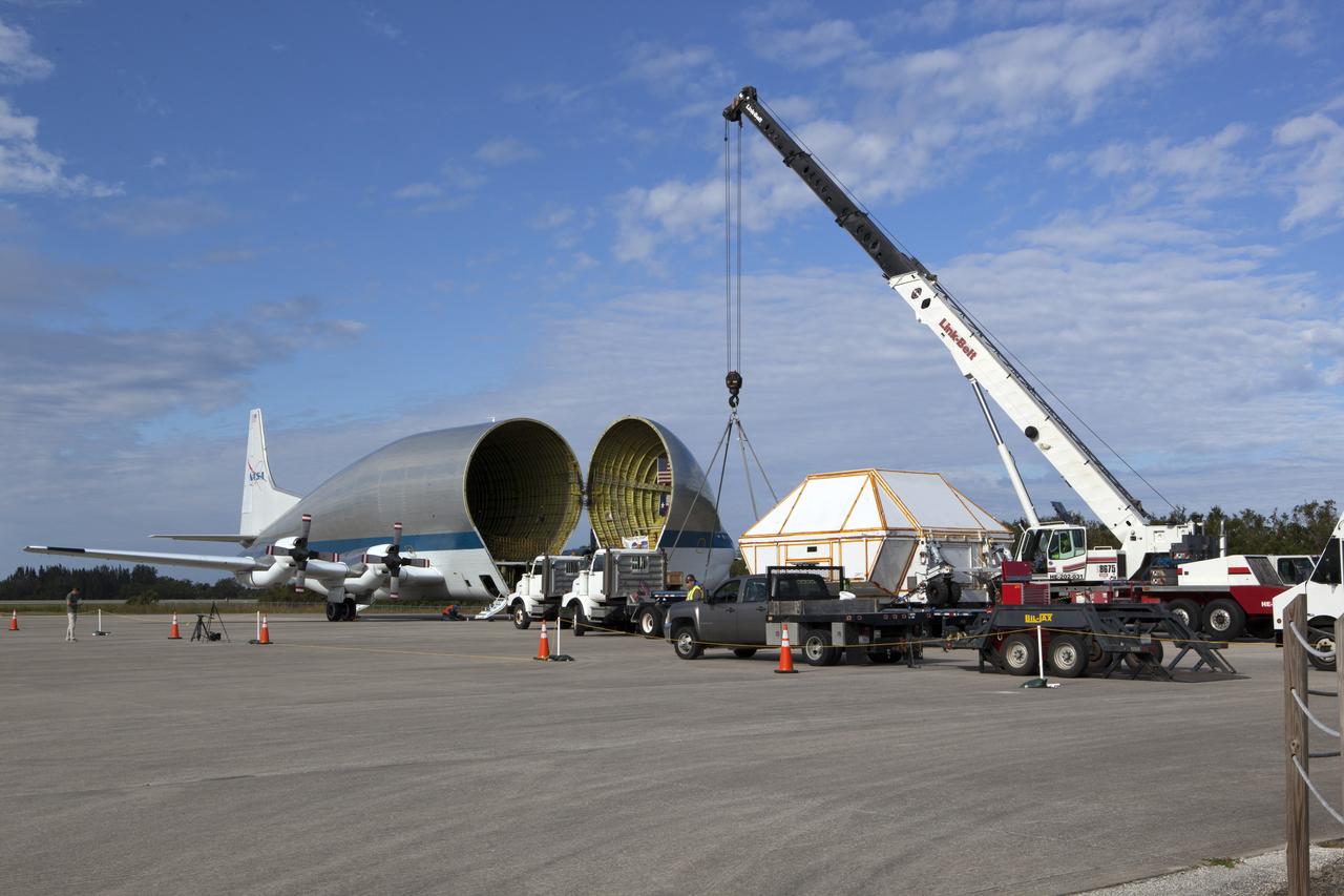 After arriving at the Shuttle Landing Facility operated by Space Florida at NASA's Kennedy Space Center in Florida, the agency's Super Guppy aircraft was opened and the container holding the Orion crew module structural test article (STA) was offloaded. A crane was used to lower the container onto a transporter. The test article will be moved to the Neil Armstrong Operations and Checkout Building high bay for further testing. The Orion spacecraft will launch atop NASA’s Space Launch System rocket on EM-1, its first deep space mission, in late 2018.
