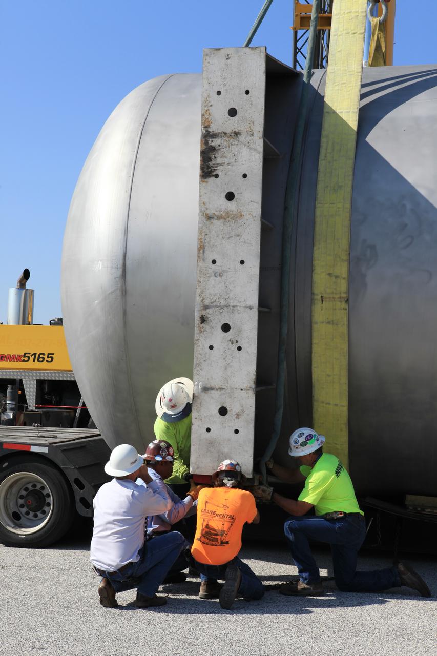 A new liquid hydrogen separator tank arrives at NASA's Kennedy Space Center in Florida. Construction workers check lines as a crane is attached to the tank to lift and rotate it before it is delivered to Launch Pad 39B. The new separator/storage tank will be added to the pad's existing hydrogen vent system to assure gaseous hydrogen is delivered downstream to the flare stack. The 60,000 gallon tank was built by INOXCVA, in Baytown, Texas, a subcontractor of Precision Mechanical Inc. in Cocoa Florida. The new tank will support all future launches from the pad.