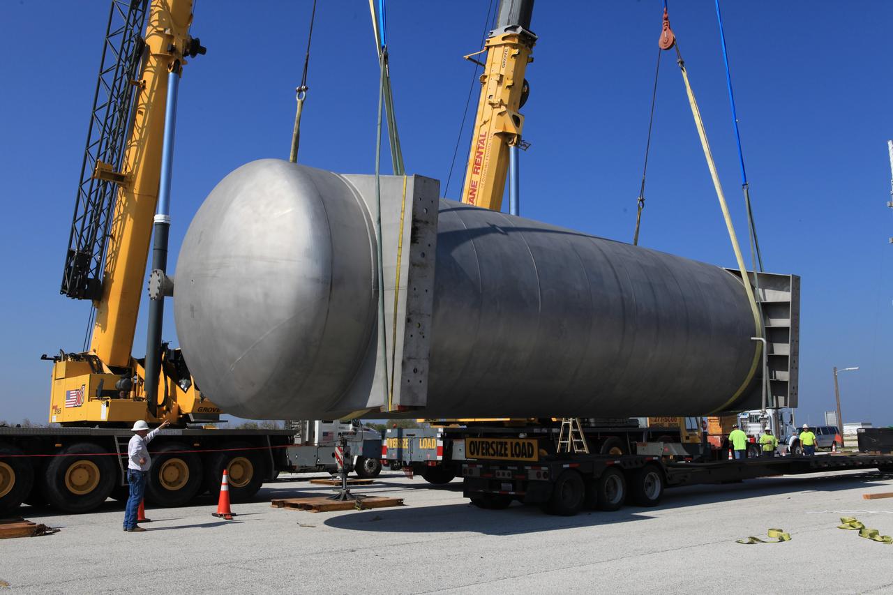 A new liquid hydrogen separator tank arrives at NASA's Kennedy Space Center in Florida. A crane has been attached to the tank to lift and rotate it before it is delivered to Launch Pad 39B. The new separator/storage tank will be added to the pad's existing hydrogen vent system to assure gaseous hydrogen is delivered downstream to the flare stack. The 60,000 gallon tank was built by INOXCVA, in Baytown, Texas, a subcontractor of Precision Mechanical Inc. in Cocoa Florida. The new tank will support all future launches from the pad.