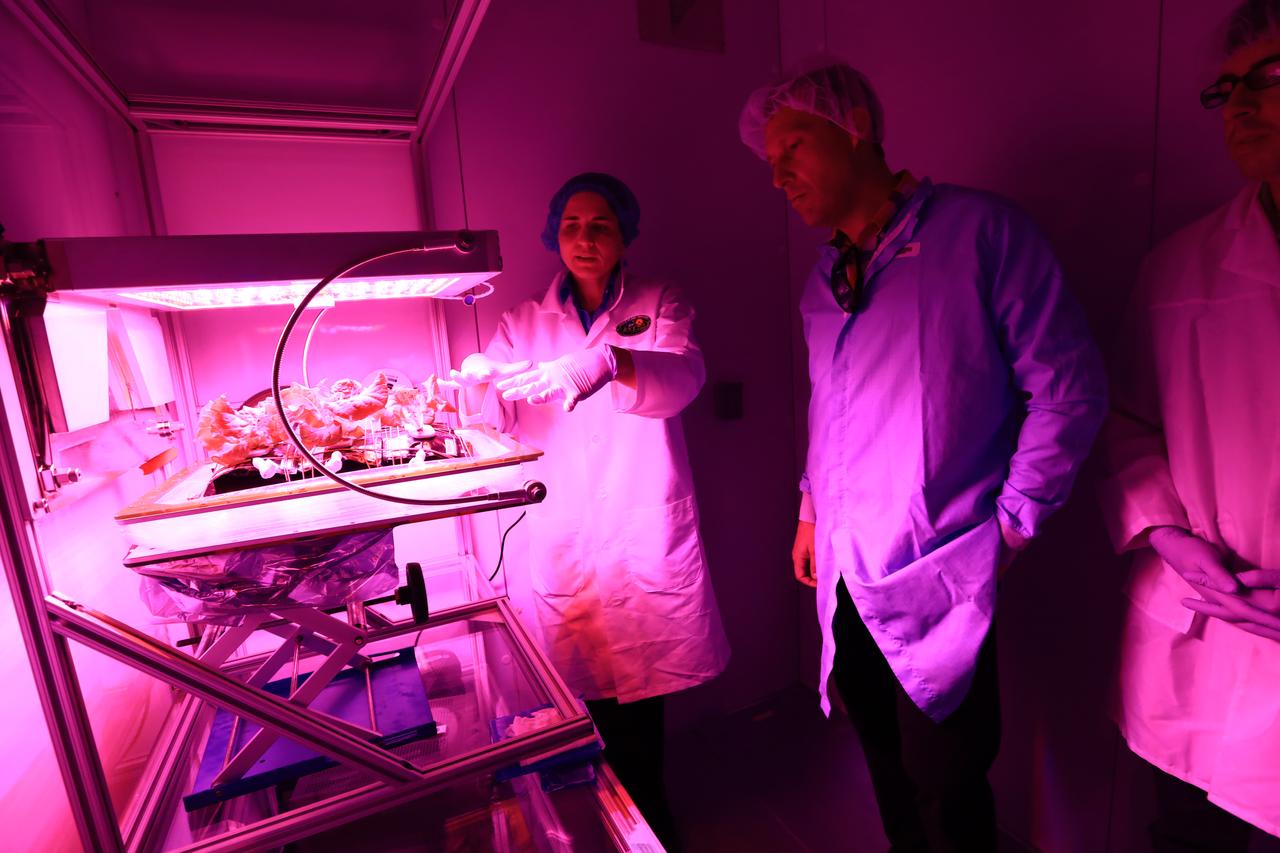 Thomas Zurbuchen, in plaid shirt, NASA's associate administrator for the Science Mission Directorate, listens to a presentation at the Space Station Processing Facility at NASA's Kennedy Space Center in Florida.