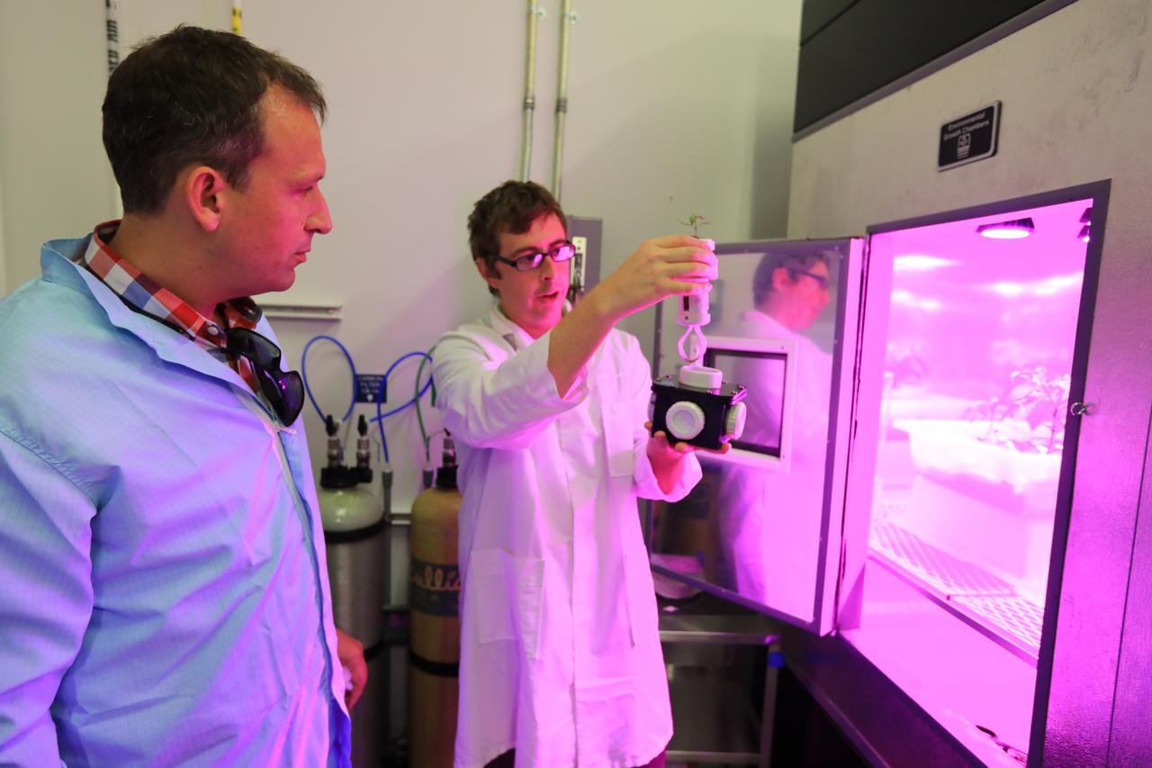 Thomas Zurbuchen, in plaid shirt, NASA's associate administrator for the Science Mission Directorate, listens to a presentation at the Space Station Processing Facility at NASA's Kennedy Space Center in Florida. 