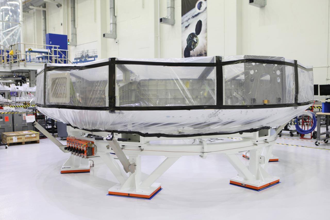 Inside the Neil Armstrong Operations and Checkout Building high bay at NASA’s Kennedy Space Center in Florida, a protective cover is installed around the Orion crew module adapter (CMA) for Exploration Mission 1 (EM-1) for its move to a clean room. The CMA will undergo propellant and environmental control and life support system tube installation and welding. The adapter will connect the Orion crew module to the European Space Agency-provided service module. The Orion spacecraft will launch atop NASA’s Space Launch System rocket on EM-1, its first deep space mission, in late 2018.