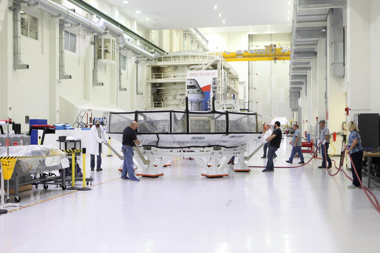 Inside the Neil Armstrong Operations and Checkout Building high bay at NASA’s Kennedy Space Center in Florida, Lockheed Martin technicians begin to move the Orion crew module adapter (CMA) for Exploration Mission 1 (EM-1) to a clean room. The CMA will undergo propellant and environmental control and life support system tube installation and welding. The adapter will connect the Orion crew module to the European Space Agency-provided service module. The Orion spacecraft will launch atop NASA’s Space Launch System rocket on EM-1, its first deep space mission, in late 2018.