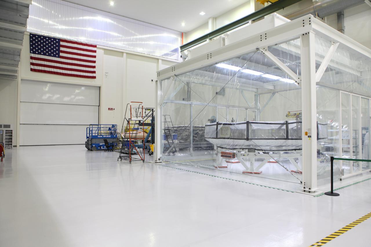 Inside the Neil Armstrong Operations and Checkout Building high bay at NASA’s Kennedy Space Center in Florida, the Orion crew module adapter (CMA) for Exploration Mission 1 (EM-1) is in a clean room with protective walls secured around it. The adapter will undergo propellant and environmental control and life support system tube installation and welding. The adapter will connect the Orion crew module to the European Space Agency-provided service module. The Orion spacecraft will launch atop NASA’s Space Launch System rocket on EM-1, its first deep space mission, in late 2018.