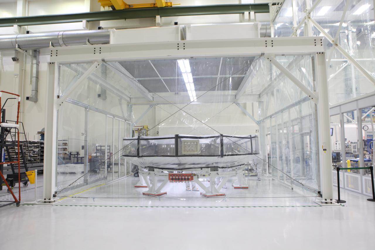 Inside the Neil Armstrong Operations and Checkout Building high bay at NASA’s Kennedy Space Center in Florida, the Orion crew module adapter (CMA) for Exploration Mission 1 (EM-1) is in a clean room with protective walls secured around it. The adapter will undergo propellant and environmental control and life support system tube installation and welding. The adapter will connect the Orion crew module to the European Space Agency-provided service module. The Orion spacecraft will launch atop NASA’s Space Launch System rocket on EM-1, its first deep space mission, in late 2018. 