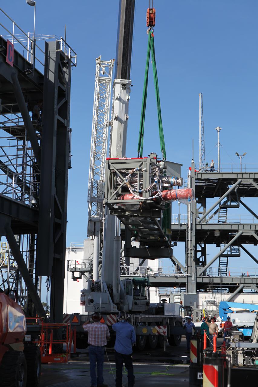 A crane is used to lift the Core State Inter-tank Umbilical (CSITU) for NASA's Space Launch System (SLS) at the Launch Equipment Test Facility at the agency's Kennedy Space Center in Florida. The CSITU will be attached to the "C" tower of the Vehicle Motion Simulator 2 test fixture. The umbilical will undergo a series of tests to confirm it is functioning properly and ready to support the SLS rocket for launch. The CSITU is a swing arm umbilical that will connect to the SLS core stage inter-tank. The umbilical's main function is to vent gaseous hydrogen from the core stage. The arm also provides conditioned air, pressurized gases, and power and data connection to the core stage. The center’s Engineering Directorate and the Ground Systems Development and Operations Program are overseeing processing and testing of the umbilicals.