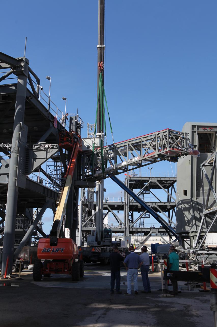 A crane moves the Core State Inter-tank Umbilical (CSITU) for NASA's Space Launch System (SLS) closer for attachment to the "C" tower of the Vehicle Motion Simulator 2 test fixture at the Launch Equipment Test Facility at the agency's Kennedy Space Center in Florida. The umbilical will undergo a series of tests to confirm it is functioning properly and ready to support the SLS rocket for launch. The CSITU is a swing arm umbilical that will connect to the SLS core stage inter-tank. The umbilical's main function is to vent gaseous hydrogen from the core stage. The arm also provides conditioned air, pressurized gases, and power and data connection to the core stage. The center’s Engineering Directorate and the Ground Systems Development and Operations Program are overseeing processing and testing of the umbilicals. 