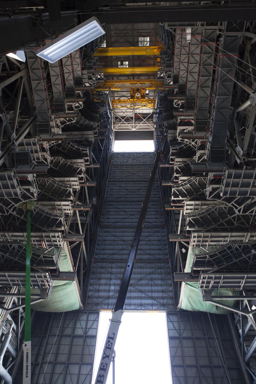 High up in High Bay 3 inside the Vehicle Assembly Building (VAB) at NASA’s Kennedy Space Center in Florida, the first half of the B-level work platforms, B south, for NASA’s Space Launch System (SLS) rocket, has been lowered into place. In view below are several levels of previously installed platforms. The B platforms are the ninth of 10 levels of work platforms that will surround and provide access to the SLS rocket and Orion spacecraft for Exploration Mission 1. The Ground Systems Development and Operations Program is overseeing upgrades and modifications to VAB High Bay 3, including installation of the new work platforms, to prepare for NASA’s Journey to Mars. 