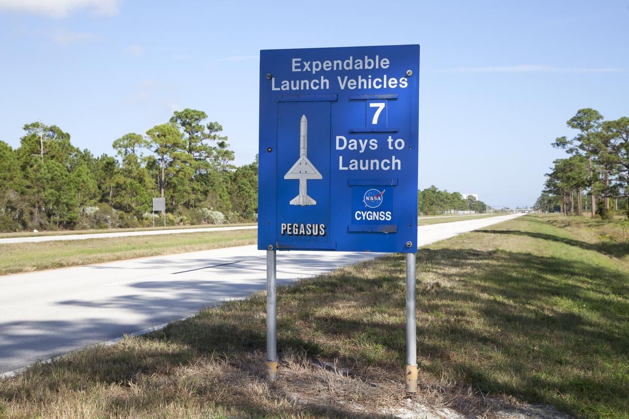 A sign just inside the gate to NASA's Kennedy Space Center in Florida notes that in seven days a Pegasus XL rocket is scheduled to launch with eight agency Cyclone Global Navigation Satellite System, or CYGNSS, spacecraft. On Dec. 12, 2016, the Orbital ATK L-1011 Stargazer, with a Pegasus XL rocket mated to the underside of the aircraft, will take off from the Skid Strip at Cape Canaveral Air Force Station. CYGNSS will launch on the Pegasus XL rocket with the L-1011 flying off shore. CYGNSS satellites will make frequent and accurate measurements of ocean surface winds throughout the life cycle of tropical storms and hurricanes. The data that CYGNSS provides will help scientists to probe key air-sea interaction processes that take place near the core of storms, which are rapidly changing and play a crucial role in the beginning and intensification of hurricanes.