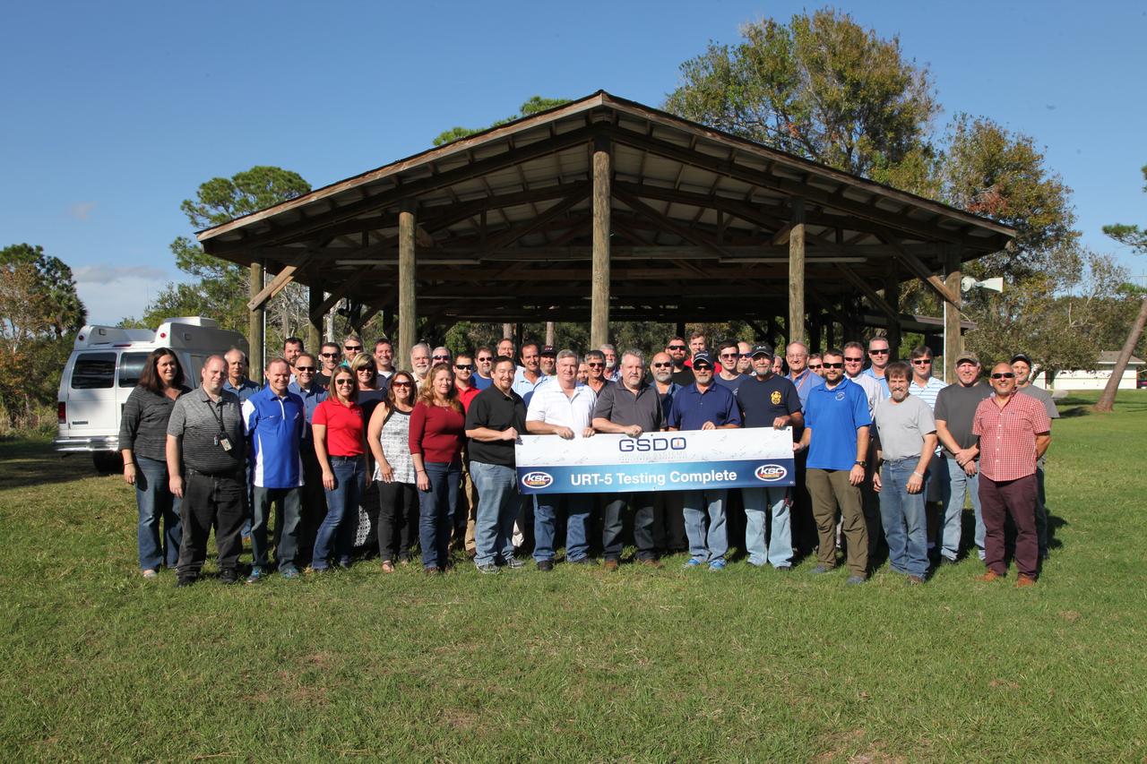 The Orion Underway Recovery Test 5 (URT-5) team celebrate a successful test during a gathering hosted by the Ground Systems Development and Operations Program and the Engineering Directorate at NASA's Kennedy Space Center in Florida. At far left is Melissa Jones, Orion Landing and Recovery director. During URT-5 in October, the team practiced recovering a test version of the Orion crew module in the Pacific Ocean, off the coast of California, and guiding it into the well deck of the USS San Diego. Over several days, the team demonstrated and evaluated new recovery processes, procedures, hardware and personnel in open waters. Orion is the exploration spacecraft designed to carry astronauts to destinations not yet explored by humans, including an asteroid and NASA's Journey to Mars. It will have emergency abort capability, sustain the crew during space travel and provide safe re-entry from deep space return velocities. Orion is scheduled to launch on NASA's Space Launch System in late 2018. For more information, visit http://www.nasa.gov/orion. 