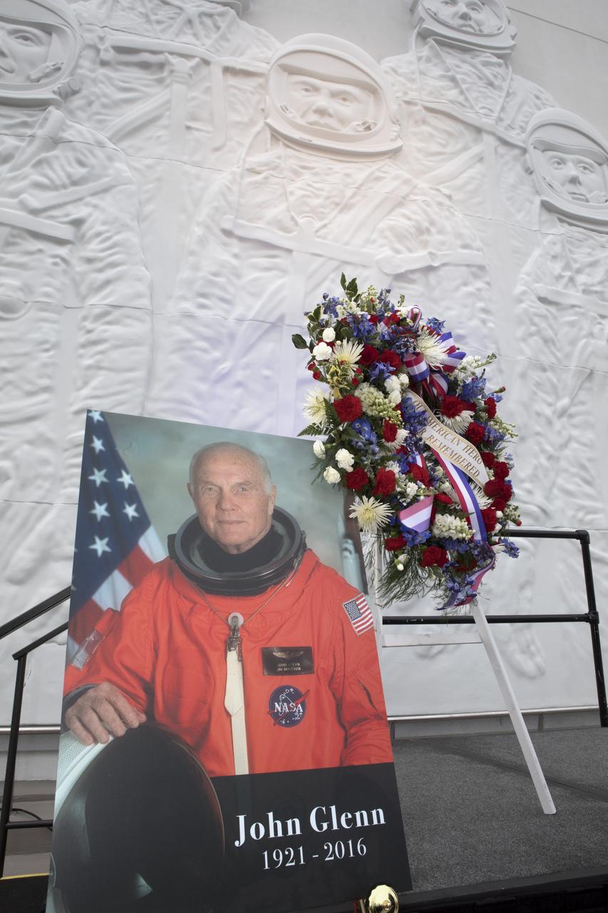 A portrait of Sen. John Glenn and a memorial wreath stand at the Heroes and Legends exhibit hall at the Kennedy Space Center Visitor Complex before a ceremony remembering the iconic astronaut who passed away Dec. 8, 2016 at age 95. Glenn, one of the first seven astronauts NASA chose to fly the first missions of the Space Age, gained worldwide acclaim during his Mercury mission that made him the first American to orbit the Earth. He flew again in 1998 aboard space shuttle Discovery at age 77.
