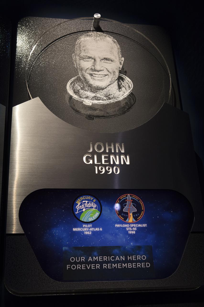 A plaque inside the Heroes and Legends exhibit hall at the Kennedy Space Center Visitor Complex shows astronaut Sen. John Glenn, along with his mission insignias for Friendship 7 and STS-95, the two flights he made into space. Glenn, who passed away Dec. 8, 2016 at age 95, was the last surviving member of NASA's original astronaut class. He gained worldwide acclaim during his Mercury mission that made him the first American to orbit the Earth. He flew again in 1998 aboard space shuttle Discovery at age 77.  