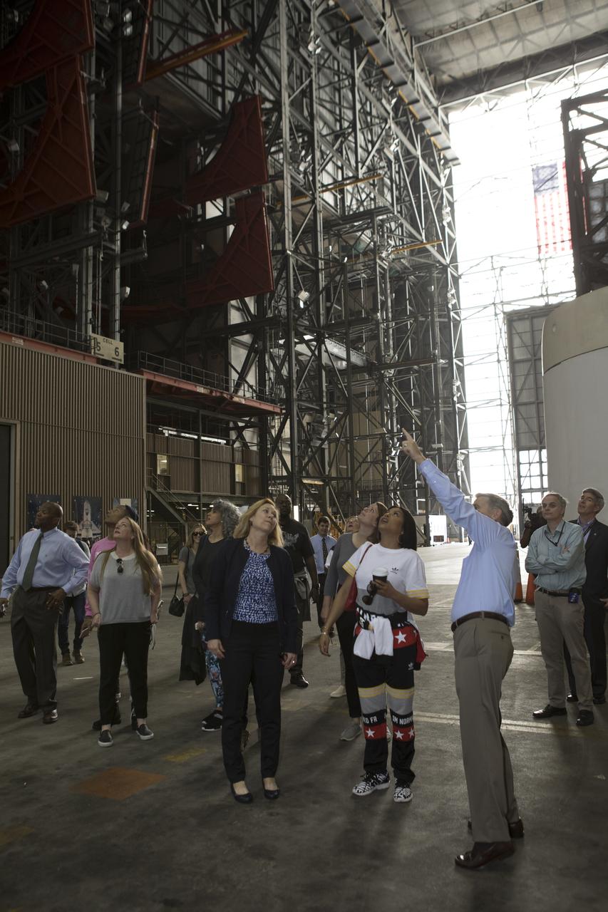 Kennedy Space Center Director Bob Cabana (pointing) provides a tour for cast and crew members of the upcoming motion picture "Hidden Figures." The group is walking thought the transfer aisle of the Vehicle Assembly Building. The movie is based on the book of the same title, by Margot Lee Shetterly. It chronicles the lives of Katherine Johnson, Dorothy Vaughan and Mary Jackson, three African-American women who worked for NASA as human "computers.” Their mathematical calculations were crucial to the success of Project Mercury missions including John Glenn’s orbital flight aboard Friendship 7 in 1962. The film is due in theaters in January 2017.