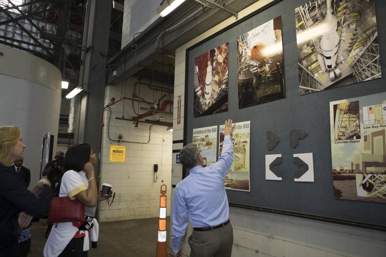 Kennedy Space Center Director Bob Cabana points to a display during a tour for cast and crew members of the upcoming motion picture "Hidden Figures." The group is walking thought the transfer aisle of the Vehicle Assembly Building. The movie is based on the book of the same title, by Margot Lee Shetterly. It chronicles the lives of Katherine Johnson, Dorothy Vaughan and Mary Jackson, three African-American women who worked for NASA as human "computers.” Their mathematical calculations were crucial to the success of Project Mercury missions including John Glenn’s orbital flight aboard Friendship 7 in 1962. The film is due in theaters in January 2017.