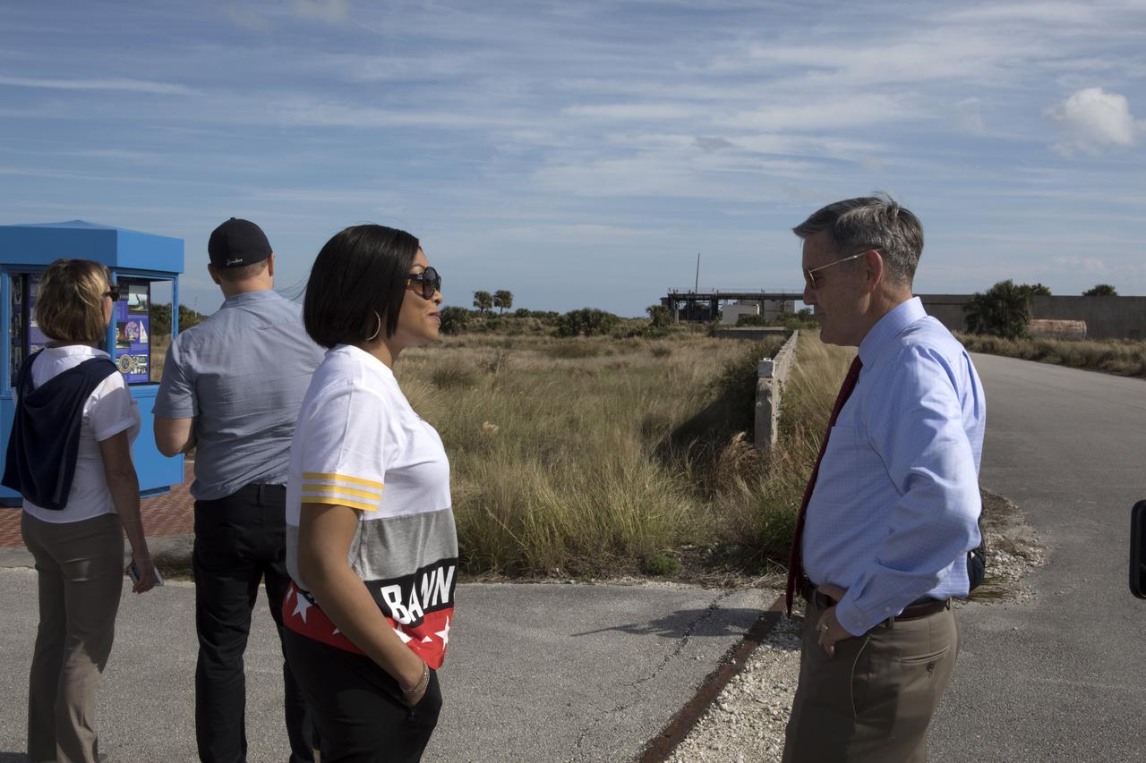 Kennedy Space Center Director Bob Cabana, right, provides a tour for cast and crew members of the upcoming motion picture "Hidden Figures." In the background is Launch Pad 14 at Cape Canaveral Air Force Station. The pad which was the location of the launch of John Glenn and three other astronauts who flew orbital missions during Project Mercury. With Cabana is Taraji P. Henson, who portrays Katherine Johnson in the film. The movie is based on the book of the same title, by Margot Lee Shetterly. It chronicles the lives of Katherine Johnson, Dorothy Vaughan and Mary Jackson, three African-American women who worked for NASA as human "computers.” Their mathematical calculations were crucial to the success of Project Mercury missions including Glenn’s orbital flight aboard Friendship 7 in 1962. The film is due in theaters in January 2017.