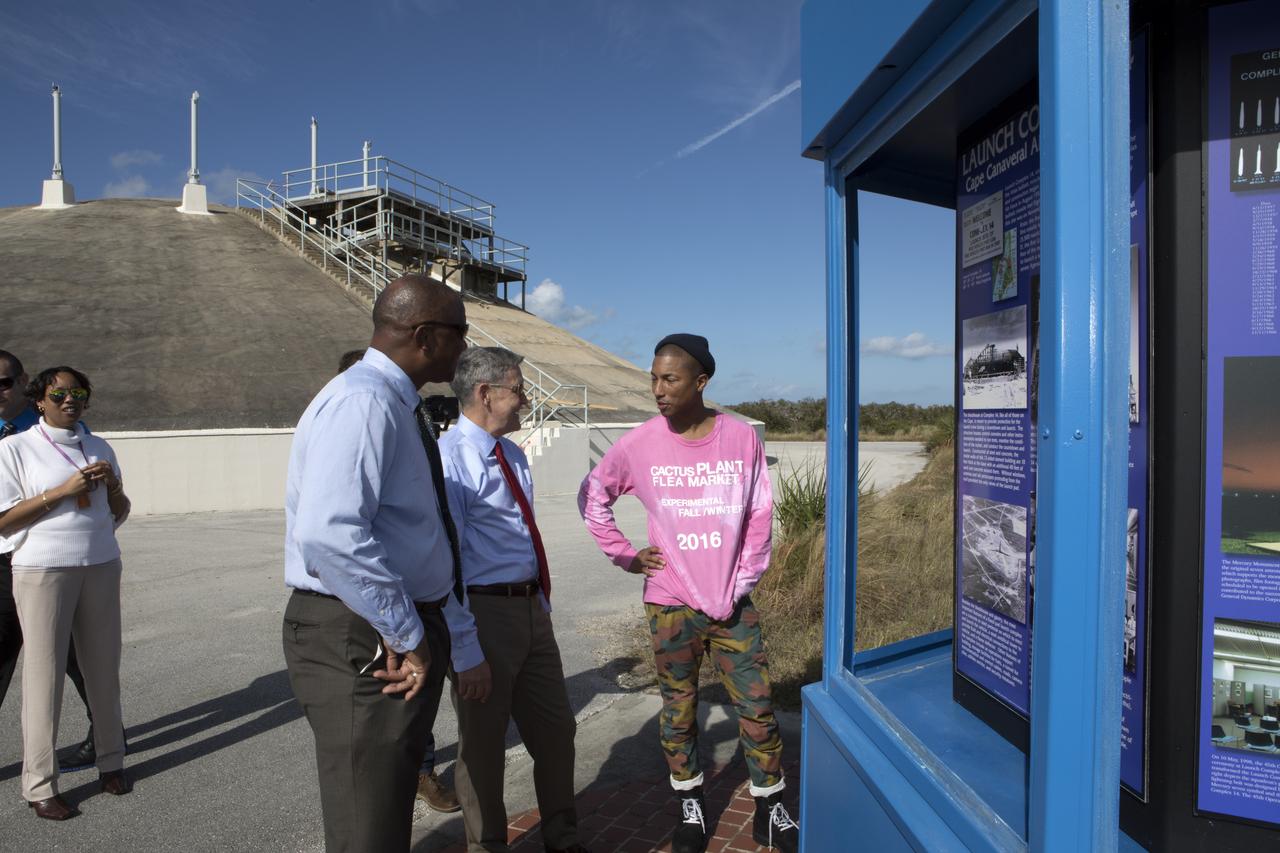 Kennedy Space Center Associate Director Kelvin Manning, left, and Center Director Bob Cabana, center, provide a tour for cast and crew members of the upcoming motion picture "Hidden Figures." They are reviewing a display at near the blockhouse at Cape Canaveral Air Force Station's Launch Pad 14 with Pharrell Williams, musician and producer of “Hidden Figures." The pad was the location of the launch of John Glenn and three other astronauts who flew orbital missions during Project Mercury. The movie is based on the book of the same title, by Margot Lee Shetterly. It chronicles the lives of Katherine Johnson, Dorothy Vaughan and Mary Jackson, three African-American women who worked for NASA as human "computers.” Their mathematical calculations were crucial to the success of Project Mercury missions including Glenn’s orbital flight aboard Friendship 7 in 1962. The film is due in theaters in January 2017.
