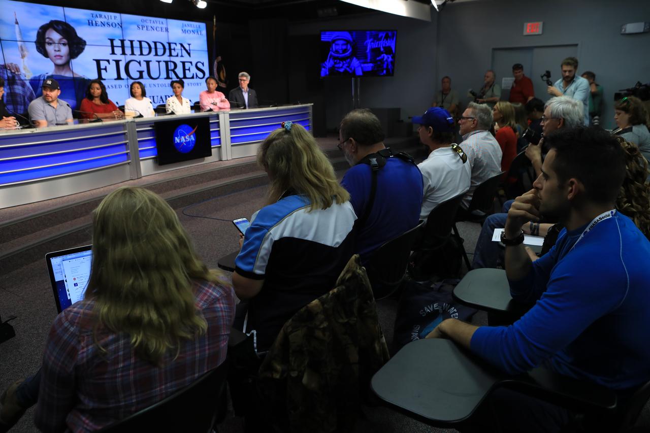 In the Press Site auditorium at the Kennedy Space Center in Florida, members of the media participate in a news conference with key individuals from the upcoming motion picture "Hidden Figures." From the left are: Ted Melfi, writer and director of “Hidden Figures”; Octavia Spencer, who portrays Dorothy Vaughan; Taraji P. Henson, who portrays Katherine Johnson in the film; Janelle Monáe, who portrays Mary Jackson; Pharrell Williams, musician and producer of “Hidden Figures"; and Bill Barry, NASA's chief historian. The movie is based on the book of the same title, by Margot Lee Shetterly. It chronicles the lives of Katherine Johnson, Dorothy Vaughan and Mary Jackson, three African-American women who worked for NASA as human "computers.” Their mathematical calculations were crucial to the success of Project Mercury missions including John Glenn’s orbital flight aboard Friendship 7 in 1962. The film is due in theaters in January 2017.