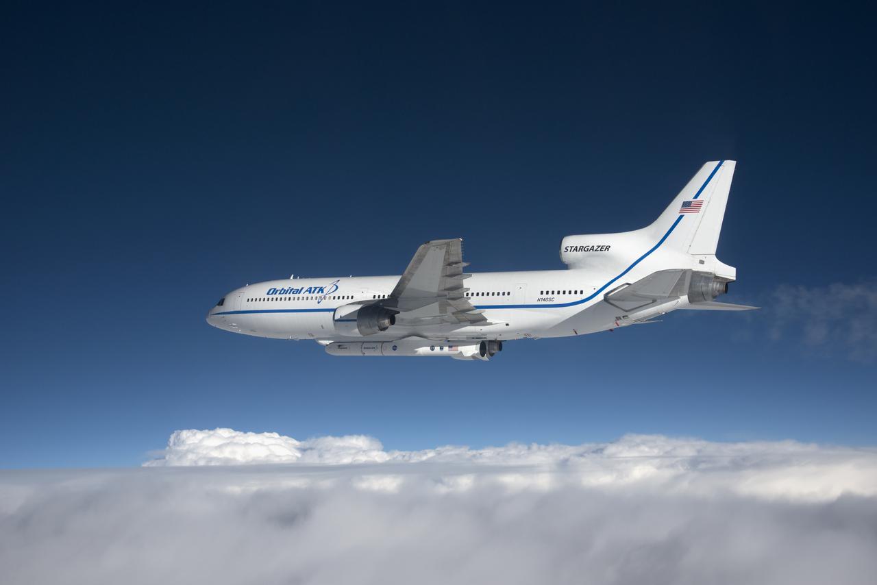 Photographed from the F-18 pathfinder aircraft, the Orbital ATK L-1011 Stargazer aircraft is seen flying over the Atlantic Ocean offshore from Daytona Beach, Florida. Attached beneath the aircraft is the Pegasus XL rocket with eight Cyclone Global Navigation Satellite System, or CYGNSS, spacecraft. The CYGNSS satellites will make frequent and accurate measurements of ocean surface winds throughout the life cycle of tropical storms and hurricanes. The data that CYGNSS provides will enable scientists to probe key air-sea interaction processes that take place near the core of storms, which are rapidly changing and play a crucial role in the beginning and intensification of hurricanes.  NOTE: The Dec. 12, 2016 launch attempt was postponed due to a hydraulic pump aboard the Orbital ATK L-1011 aircraft which is required to release the latches holding Pegasus in place, is not receiving power.