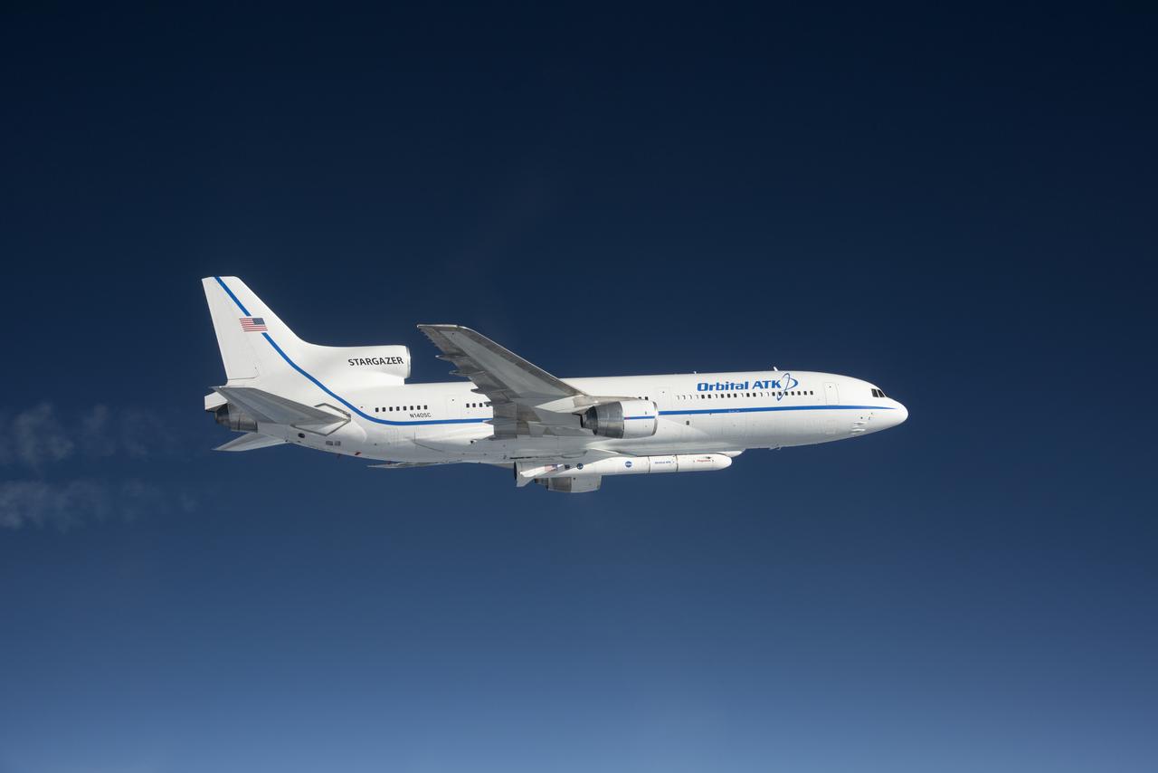Photographed from the F-18 pathfinder aircraft, the Orbital ATK L-1011 Stargazer aircraft is seen flying over the Atlantic Ocean offshore from Daytona Beach, Florida. Attached beneath the aircraft is the Pegasus XL rocket with eight Cyclone Global Navigation Satellite System, or CYGNSS, spacecraft. The CYGNSS satellites will make frequent and accurate measurements of ocean surface winds throughout the life cycle of tropical storms and hurricanes. The data that CYGNSS provides will enable scientists to probe key air-sea interaction processes that take place near the core of storms, which are rapidly changing and play a crucial role in the beginning and intensification of hurricanes.  NOTE: The Dec. 12, 2016 launch attempt was postponed due to a hydraulic pump aboard the Orbital ATK L-1011 aircraft which is required to release the latches holding Pegasus in place, is not receiving power.