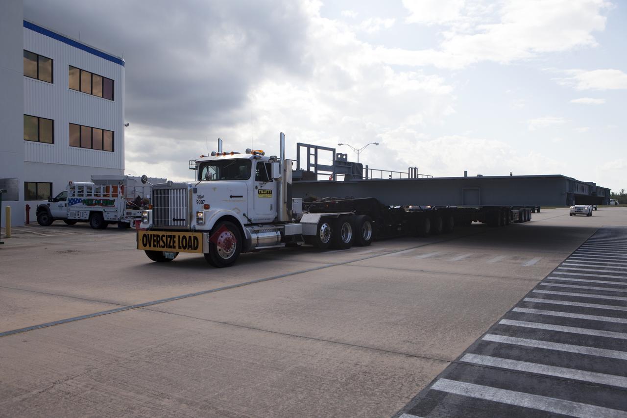 A heavy load transport truck from Tillett Heavy Hauling in Titusville, Florida, arrives at NASA’s Kennedy Space Center in Florida, carrying the second half of the A-level work platforms, A north, for the agency’s Space Launch System (SLS) rocket. This is the final platform delivered to Kennedy. The A-level platforms are the topmost platforms for High Bay 3 in the Vehicle Assembly Building (VAB). The platform will be delivered to the VAB staging area in the west parking lot. The Ground Systems Development and Operations Program is overseeing upgrades and modifications to High Bay 3 to support processing of the SLS and Orion spacecraft. A total of 10 levels of new platforms, 20 platform halves altogether, will surround the SLS rocket and Orion spacecraft and provide access for testing and processing.