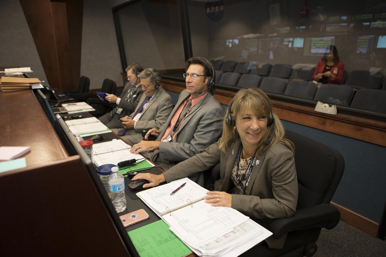 In the Mission Director's Center at Cape Canaveral Air Force Station, Amanda Mitskevich, facing the camera, is program manager for NASA's Launch Services Program (LSP) at the agency's Kennedy Space Center in Florida. Seated next to her is Chuck Dovale, deputy LSP program manager. They are monitoring the progress of preparations to launch eight Cyclone Global Navigation Satellite System, or CYGNSS, spacecraft. The CYGNSS satellites will make frequent and accurate measurements of ocean surface winds throughout the life cycle of tropical storms and hurricanes. The data that CYGNSS provides will enable scientists to probe key air-sea interaction processes that take place near the core of storms, which are rapidly changing and play a crucial role in the beginning and intensification of hurricanes. 
