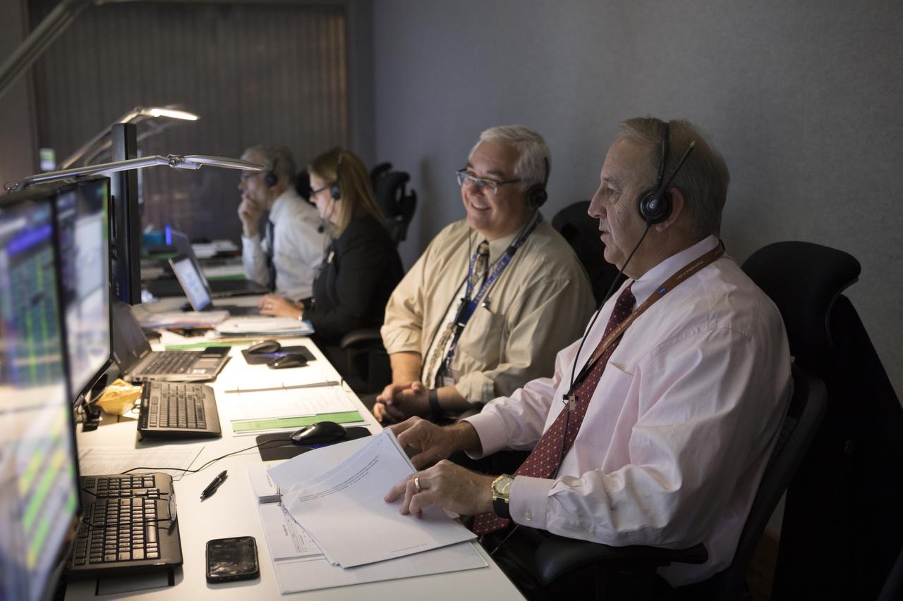 In the Mission Director's Center at Cape Canaveral Air Force Station, Andy Bundy, Avionics lead, left, and Pat Simpkins, director of Kennedy Space Center Engineering, monitor the progress of preparations to launch eight Cyclone Global Navigation Satellite System, or CYGNSS, spacecraft. The CYGNSS satellites will make frequent and accurate measurements of ocean surface winds throughout the life cycle of tropical storms and hurricanes. The data that CYGNSS provides will enable scientists to probe key air-sea interaction processes that take place near the core of storms, which are rapidly changing and play a crucial role in the beginning and intensification of hurricanes.