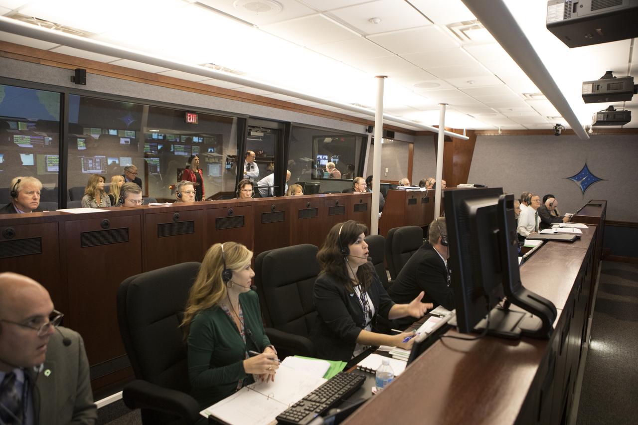 In the Mission Director's Center at Cape Canaveral Air Force Station, Dana Allender, NASA Launch Operations manager, left, and Aly Mendoza-Hill, NASA Mission manager, monitor the progress of preparations to launch eight Cyclone Global Navigation Satellite System, or CYGNSS, spacecraft. The CYGNSS satellites will make frequent and accurate measurements of ocean surface winds throughout the life cycle of tropical storms and hurricanes. The data that CYGNSS provides will enable scientists to probe key air-sea interaction processes that take place near the core of storms, which are rapidly changing and play a crucial role in the beginning and intensification of hurricanes.